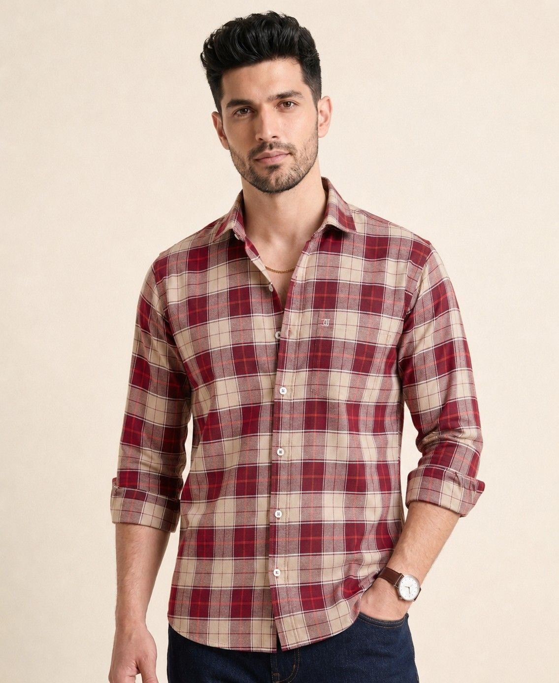 Man wearing a red and beige plaid shirt on a beige background