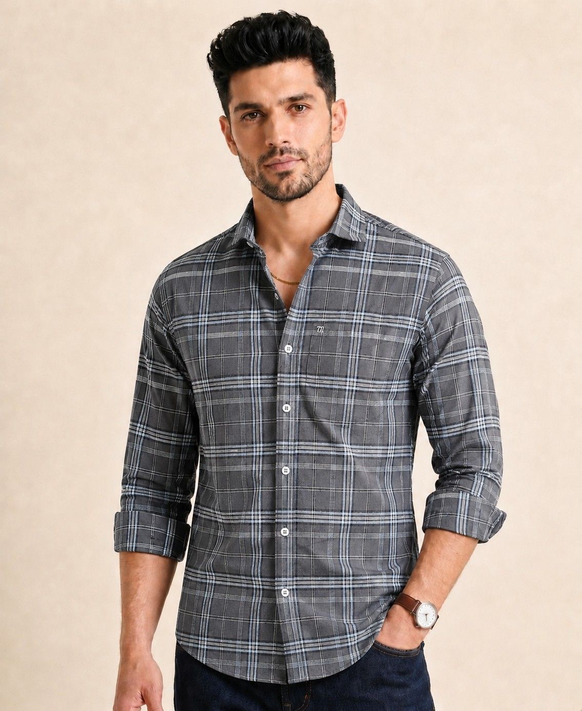 Man wearing a gray plaid shirt against a beige background