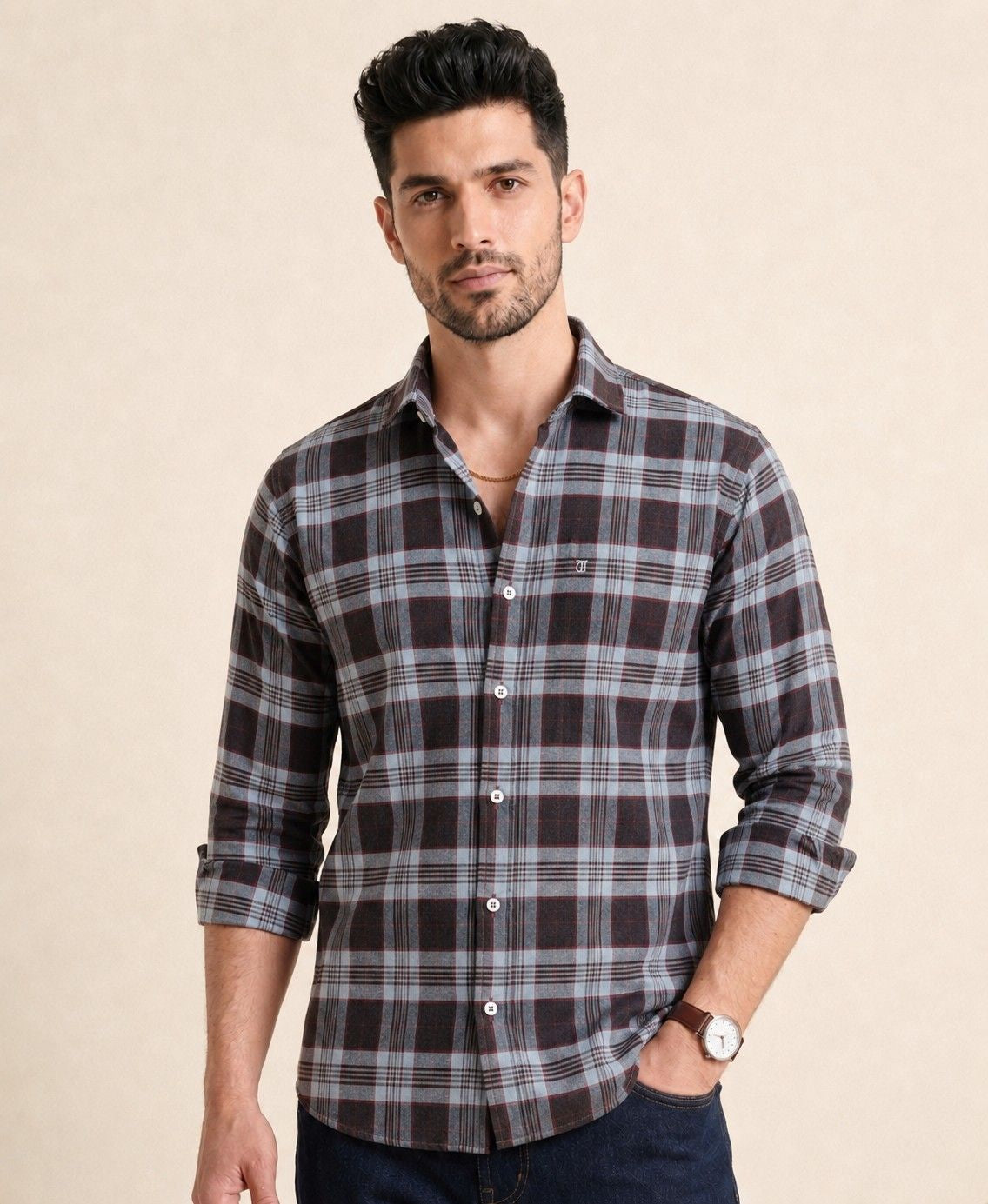 Man wearing a plaid shirt on a beige background